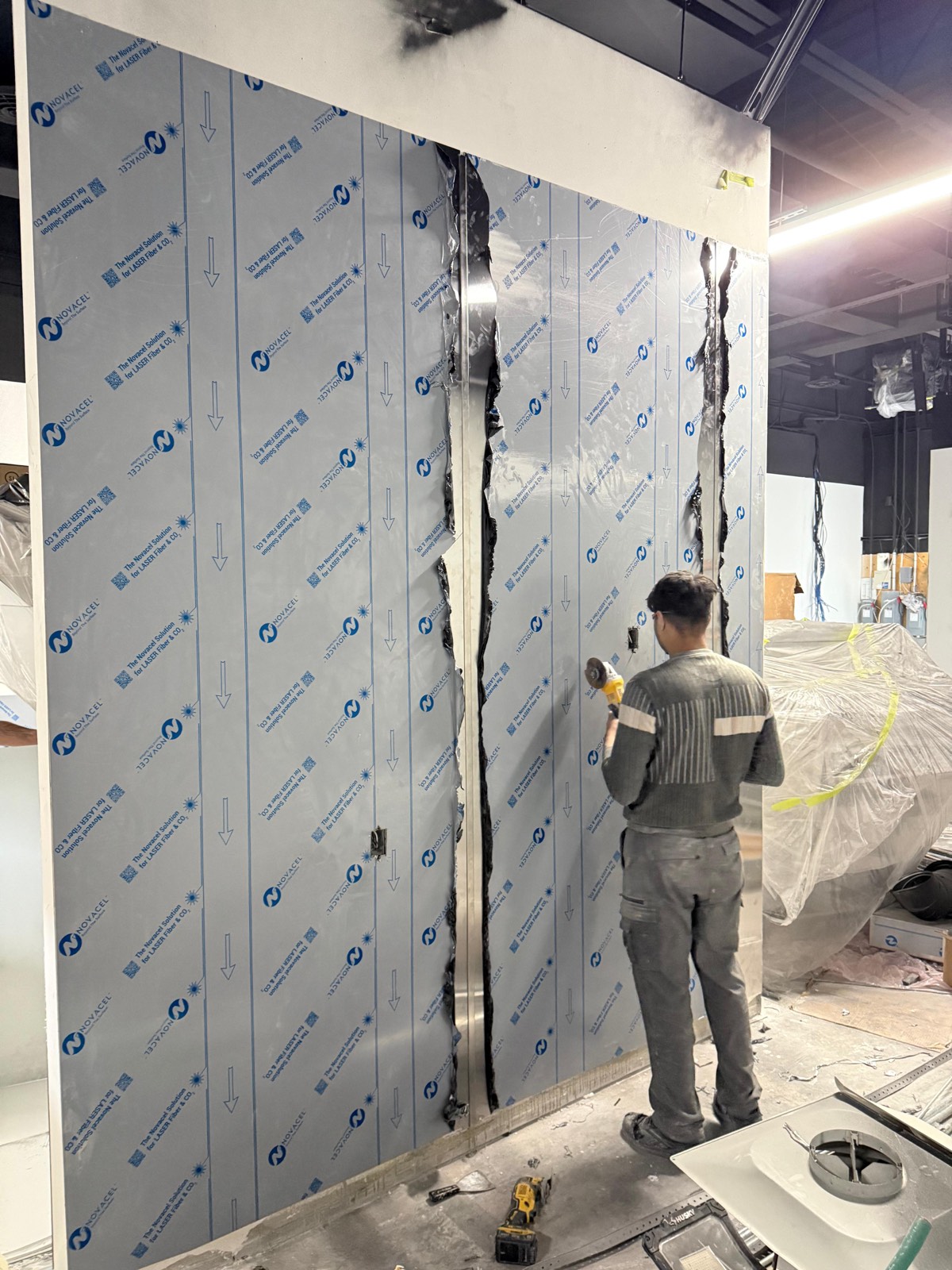 Installer fitting stainless steel wall sheets